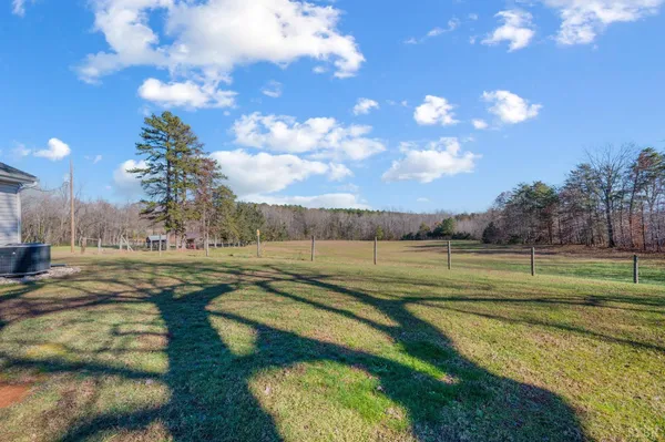a balcony with wooden floor table and chairs