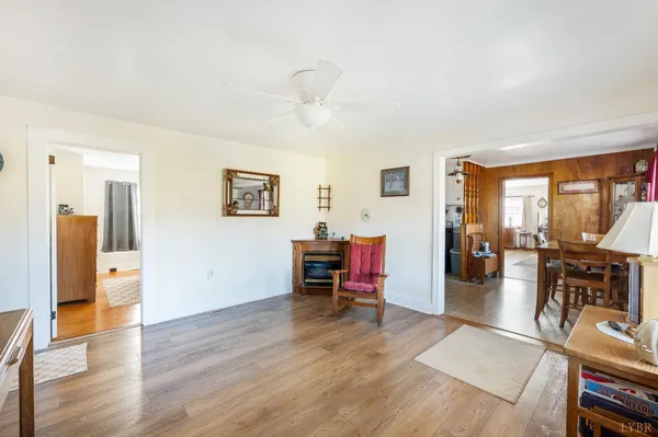 a living room with furniture a fireplace and next to a window
