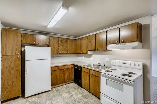 a kitchen with a sink a stove and refrigerator