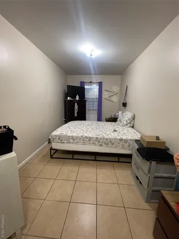 a bedroom with a bed and a stove top oven
