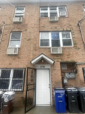 a car parked in front of a brick building