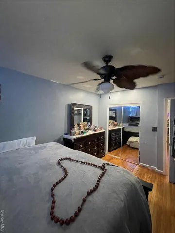 a bathroom with a granite countertop toilet sink and mirror