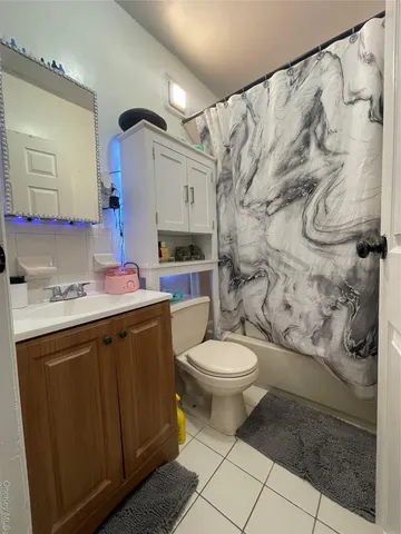 a kitchen with granite countertop a stove and cabinets