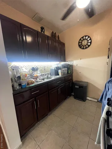 a bedroom with a bed purple white bedspread and pillows