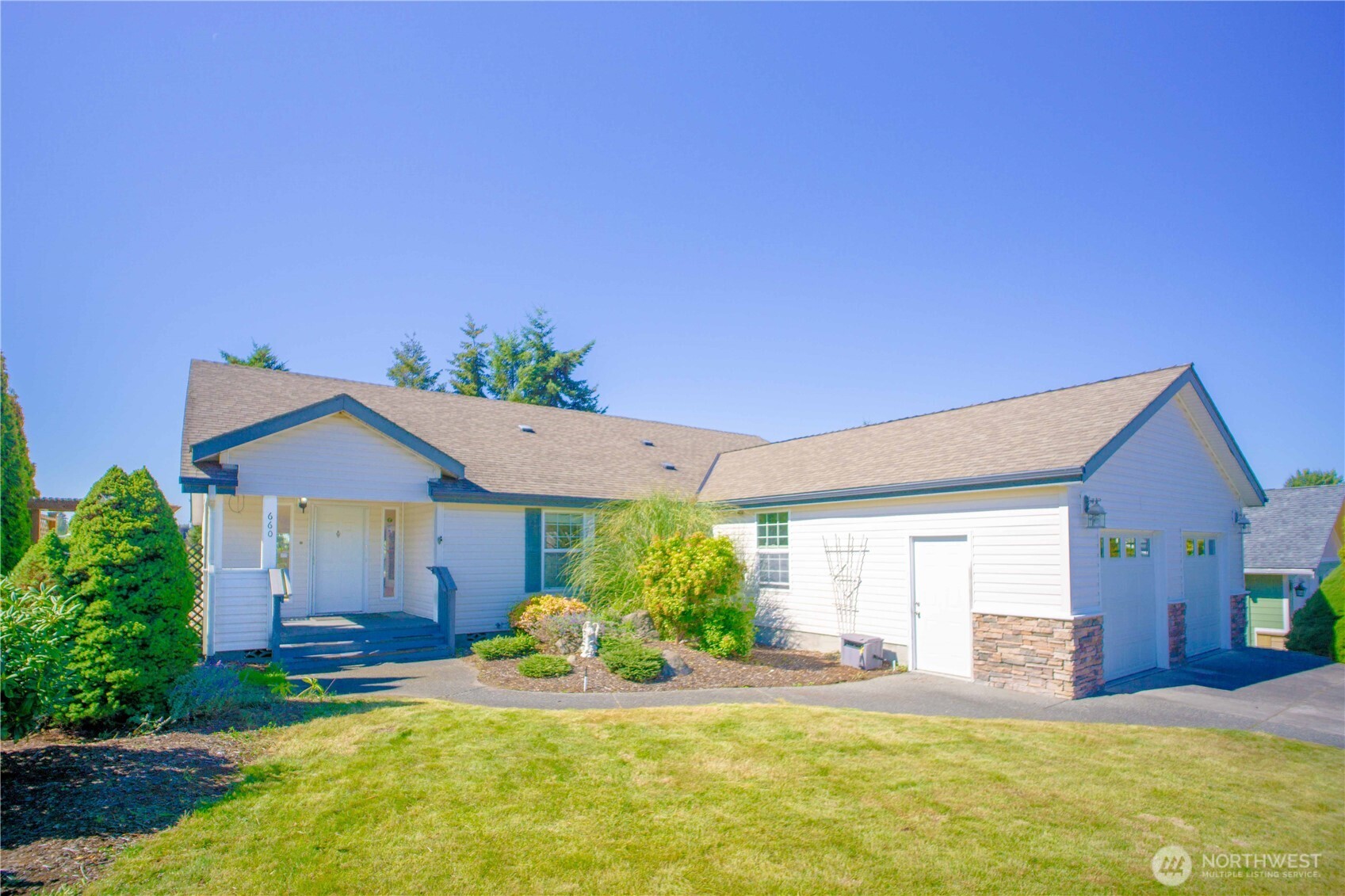 a view of a house with a patio and a yard
