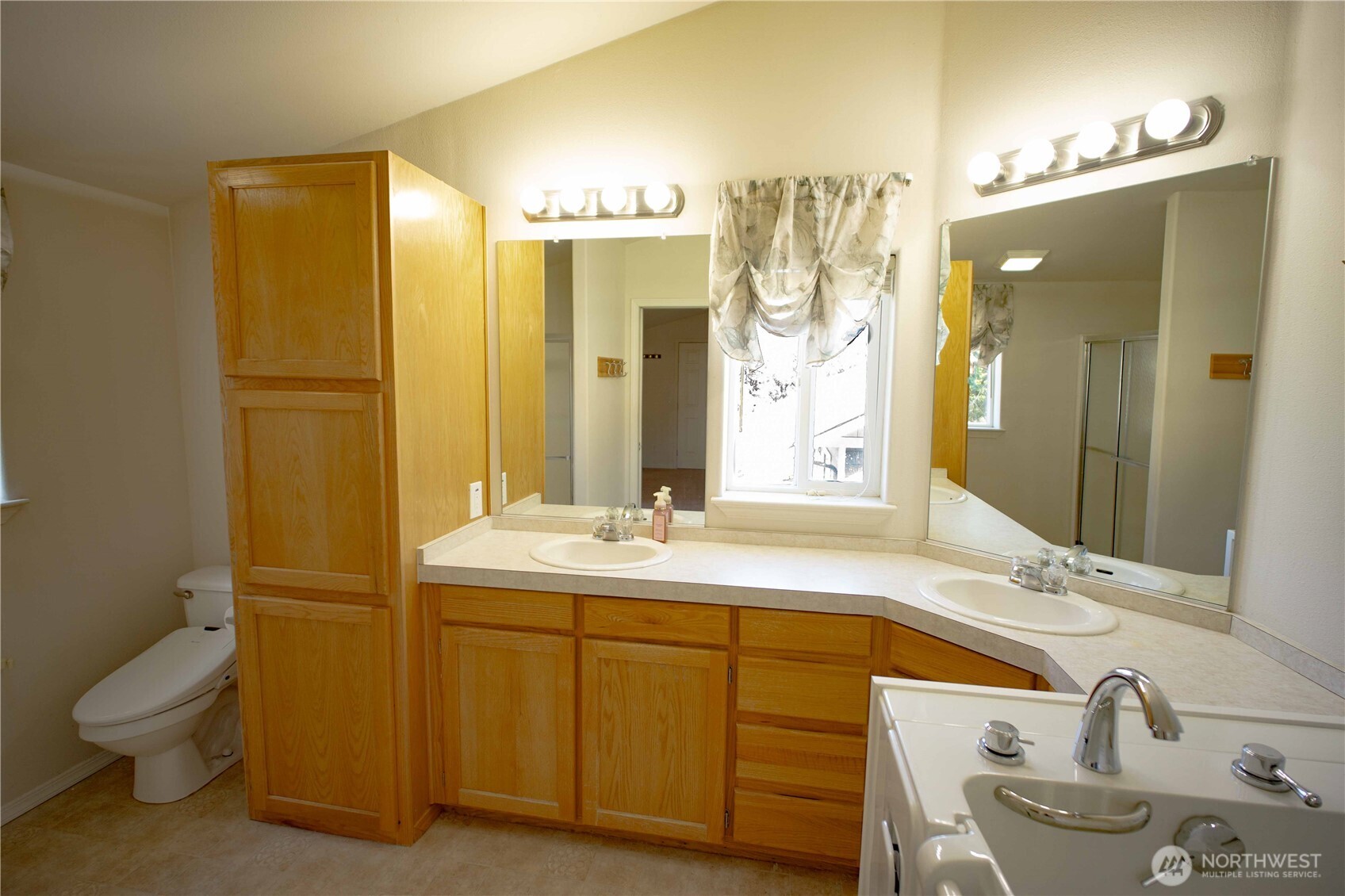 660 Elk Loop Sequim, WA 98382 - Photo 16 of 36 a bathroom with a double vanity sink mirror and toilet