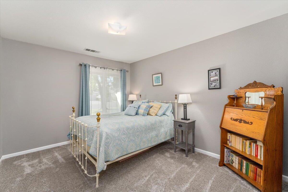 1543 Marigold Way Redding, CA 96003 - Photo 14 of 47 a bedroom with a bed and a window