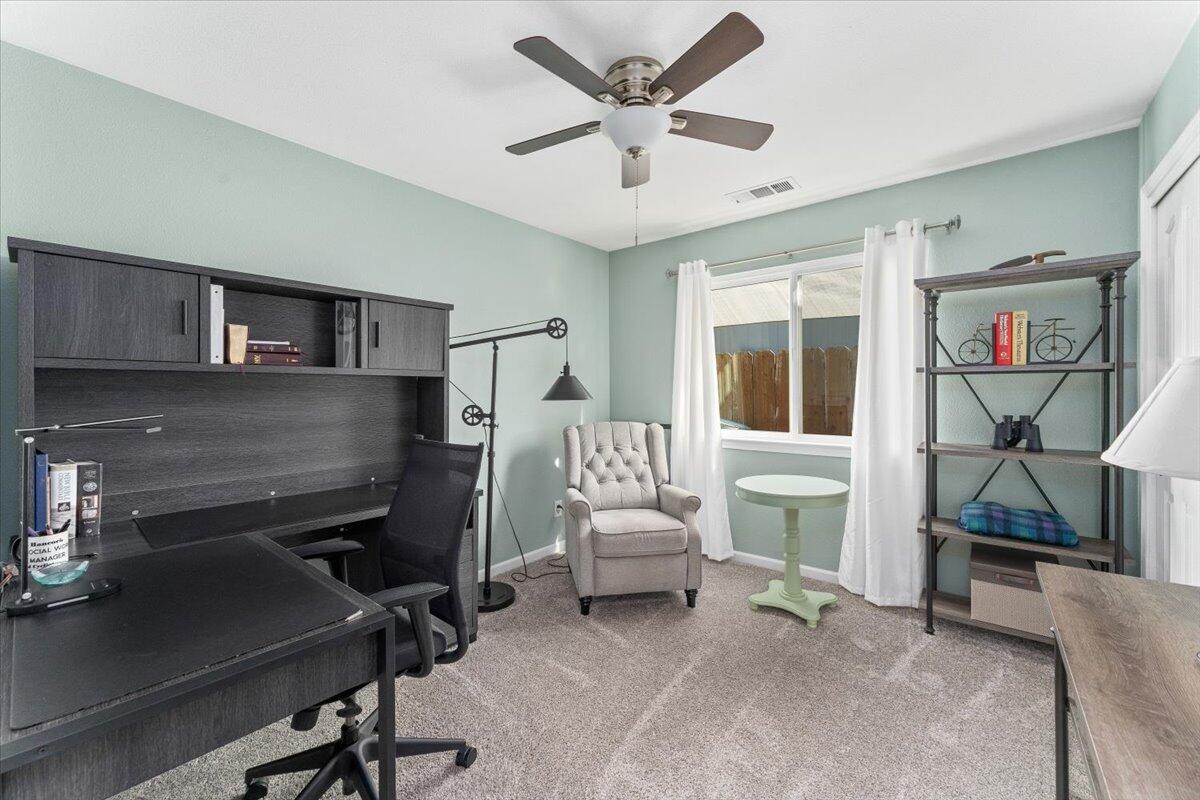 1543 Marigold Way Redding, CA 96003 - Photo 17 of 47 a view of a workspace with furniture and a livingroom
