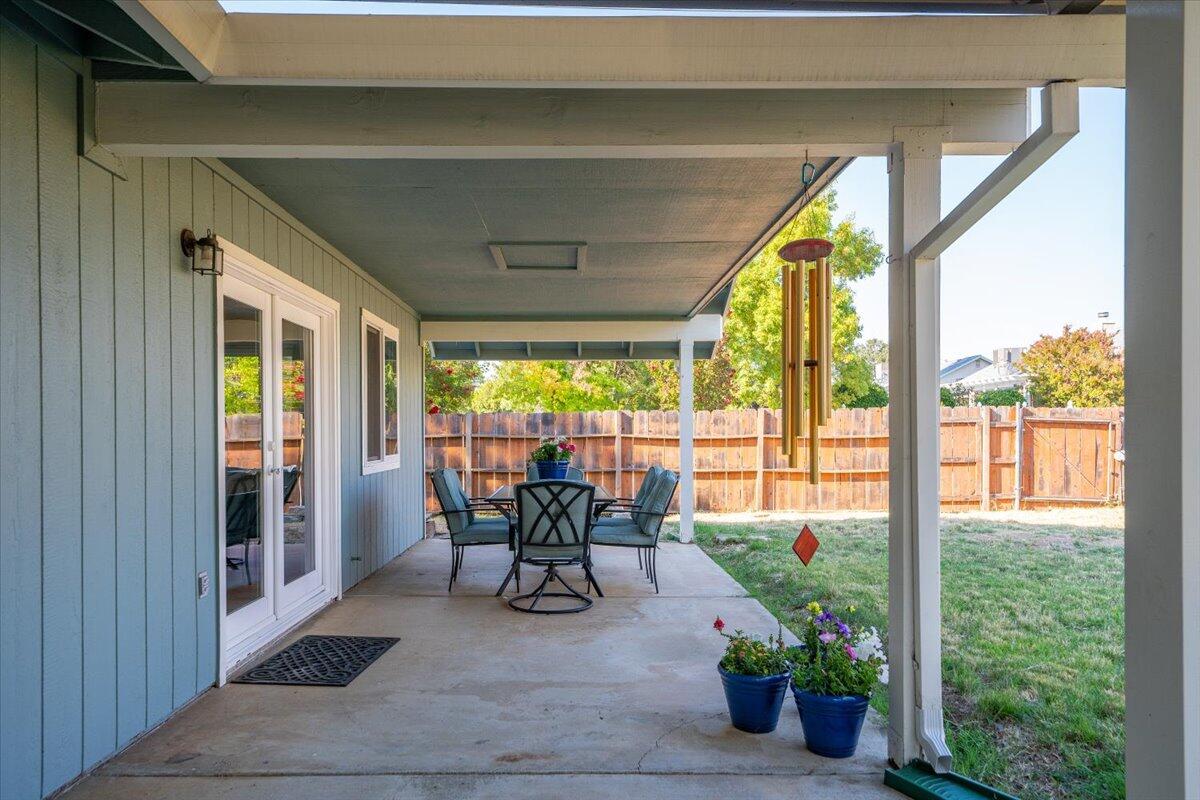 1543 Marigold Way Redding, CA 96003 - Photo 19 of 47 a view of a porch with chairs and backyard