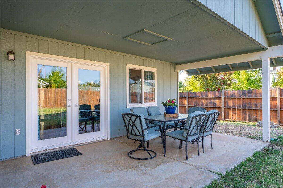 1543 Marigold Way Redding, CA 96003 - Photo 20 of 47 a view of a patio with a table and chairs