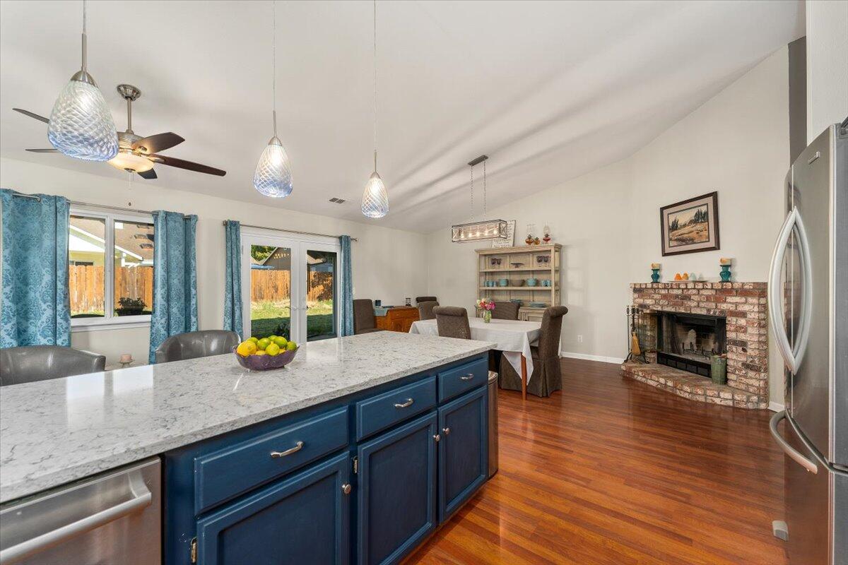 1543 Marigold Way Redding, CA 96003 - Photo 25 of 47 a kitchen with a counter space dining table and chairs