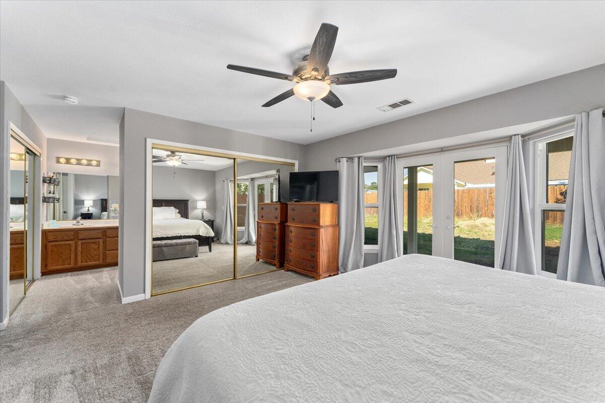 1543 Marigold Way Redding, CA 96003 - Photo 26 of 47 a large bedroom with a large bed and a large window