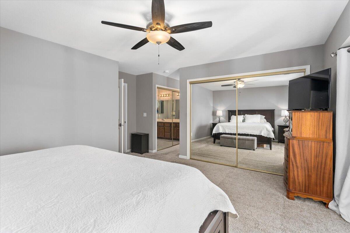 1543 Marigold Way Redding, CA 96003 - Photo 27 of 47 a bedroom with a bed and a large mirror