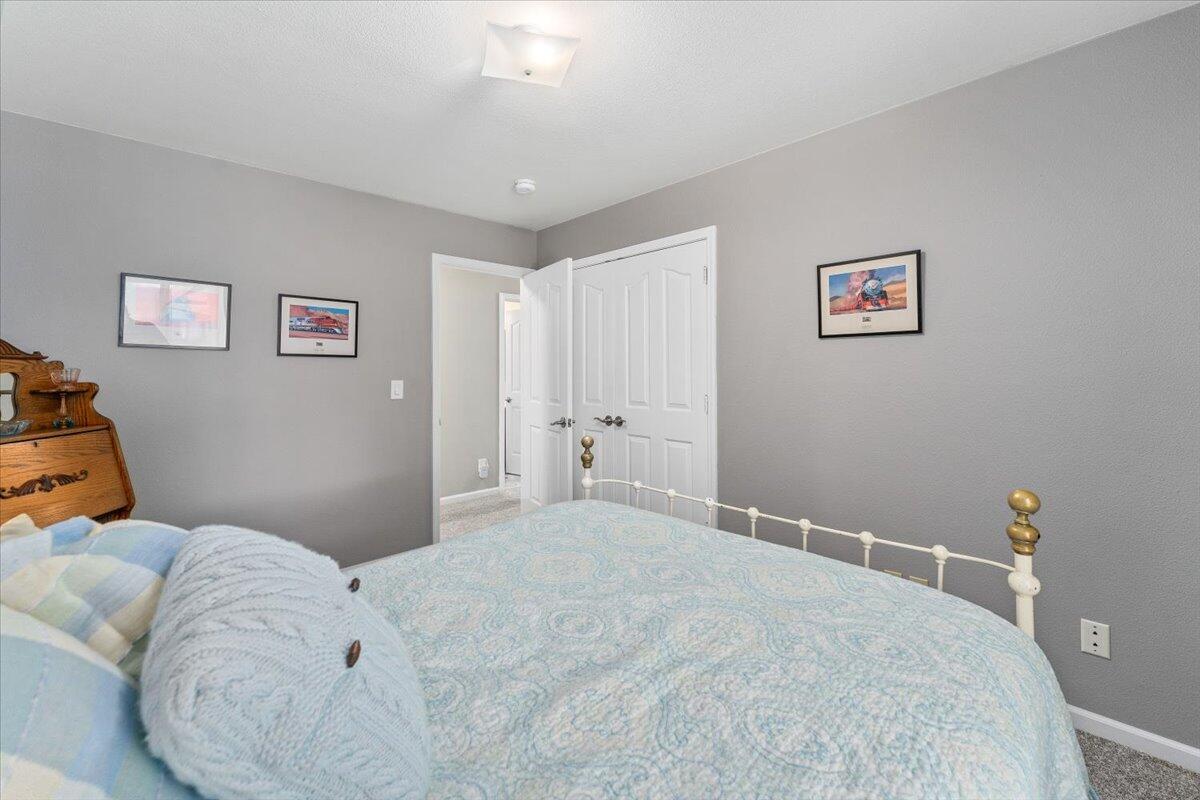 1543 Marigold Way Redding, CA 96003 - Photo 29 of 47 a bedroom with a bed and a couch