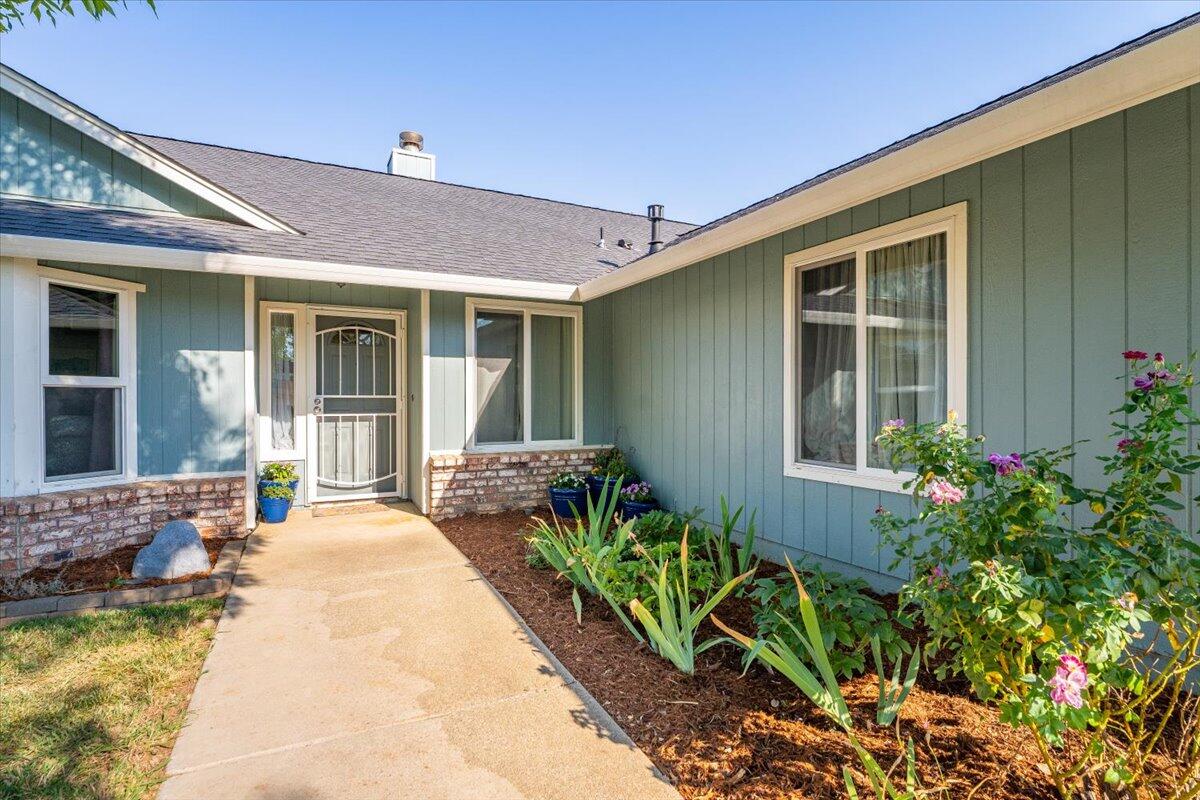 1543 Marigold Way Redding, CA 96003 - Photo 3 of 47 a view of a house with swimming pool and furniture
