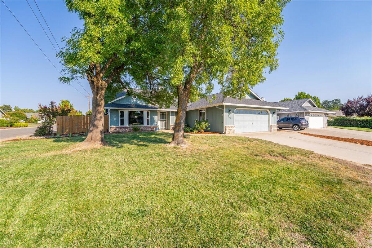 1543 Marigold Way Redding, CA 96003 - Photo 36 of 47 a front view of a house with a garden