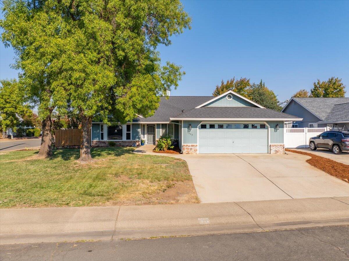 1543 Marigold Way Redding, CA 96003 - Photo 40 of 47 a front view of a house with a garden