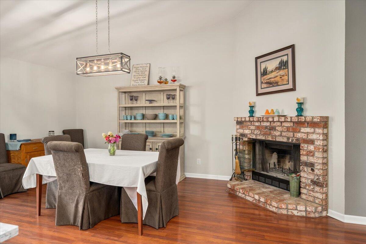 1543 Marigold Way Redding, CA 96003 - Photo 9 of 47 a view of a dining room with furniture wooden floor and a fireplace