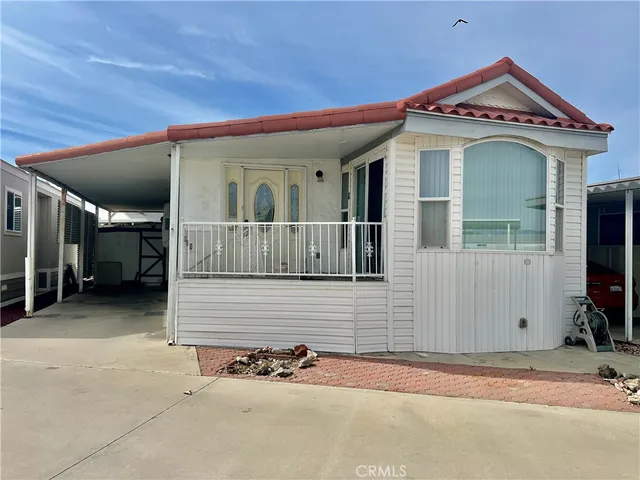 a view of a house with a small yard and wooden fence