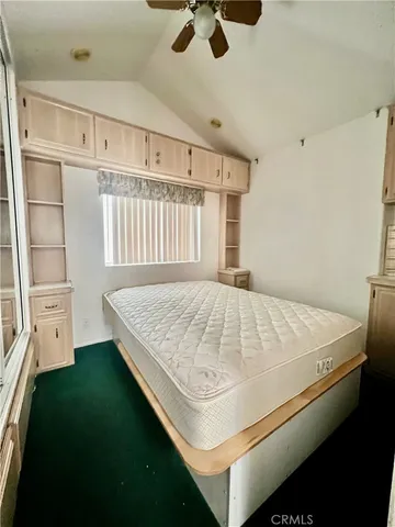 a bedroom with a bed and cabinets