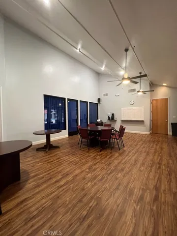 a large kitchen with stainless steel appliances granite countertop a stove and a wooden floors