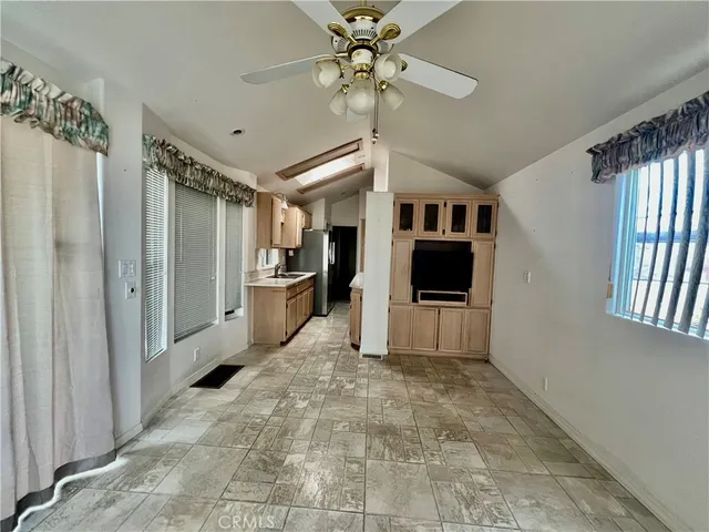 a view of a livingroom with a chandelier furniture and windows
