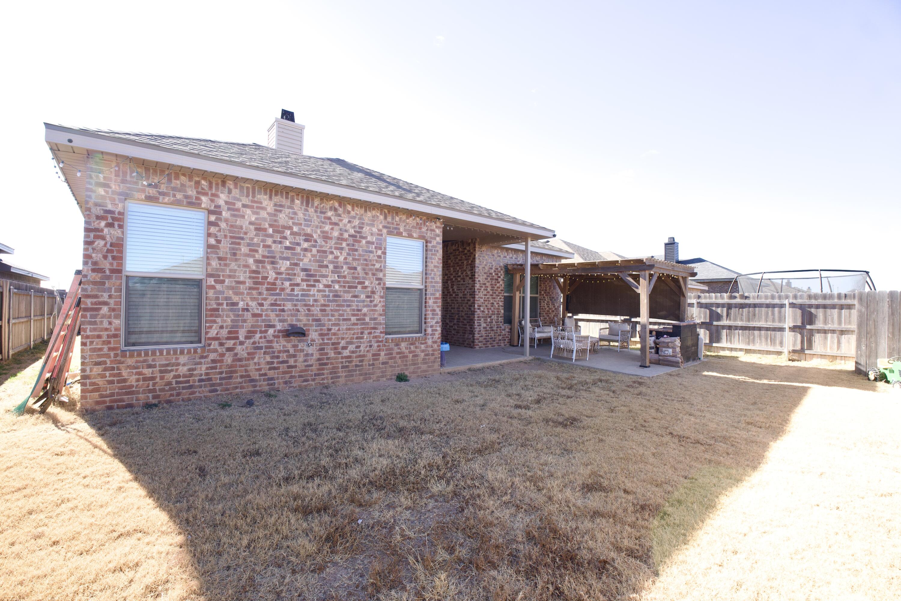 1604 137th Street Lubbock, TX 79423 - Photo 18 of 19 a view of a house with backyard and porch