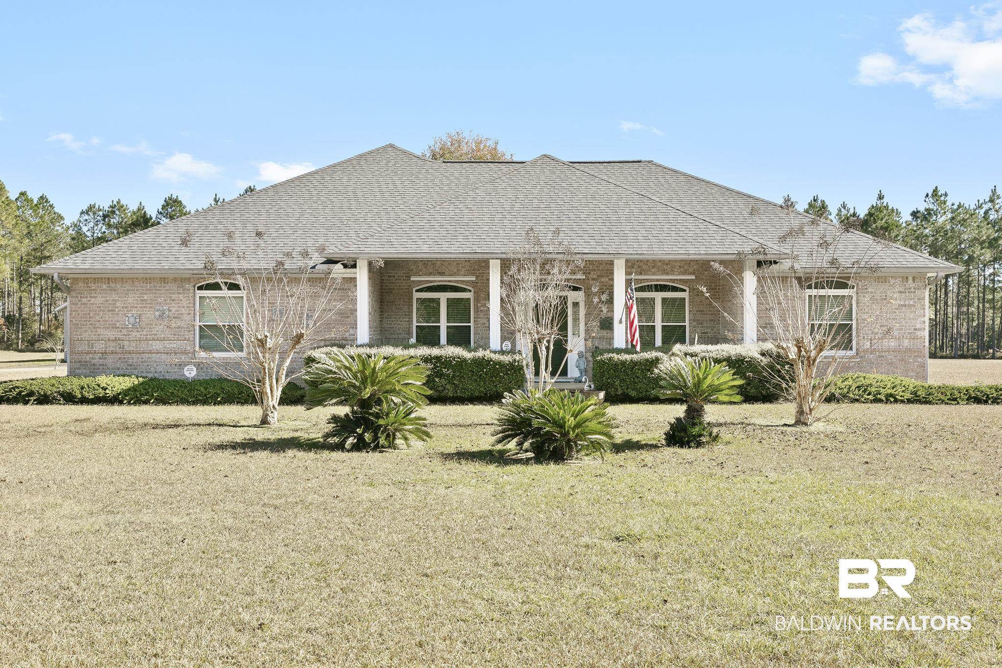 Back of house with a lawn