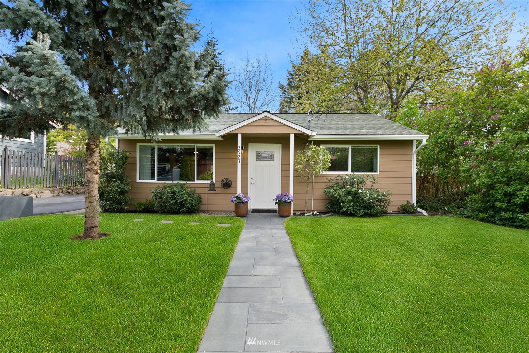 3523 Northeast 6th Street Renton, WA 98056 - Photo 1 of 27 a front view of a house with yard