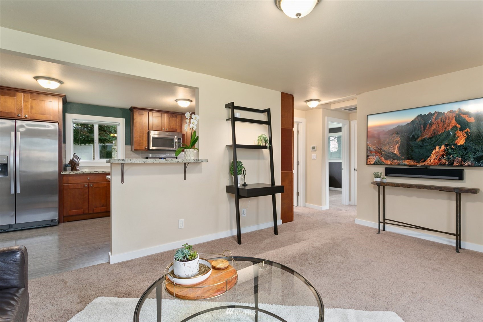 3523 Northeast 6th Street Renton, WA 98056 - Photo 6 of 27 a living room with furniture a flat screen tv and kitchen view