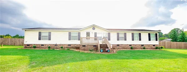 a view of house with backyard and garden