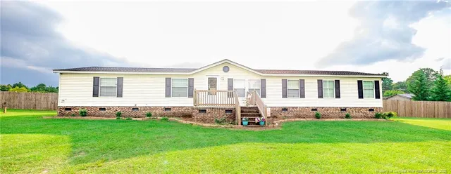 a view of house with backyard and garden