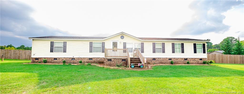 a view of house with backyard and garden