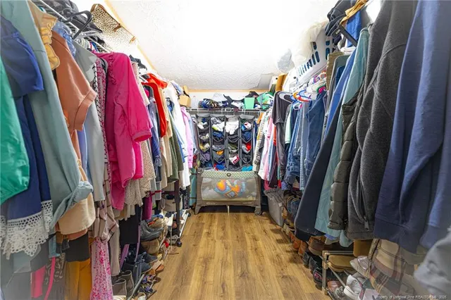 a view of walk in closet with clothes