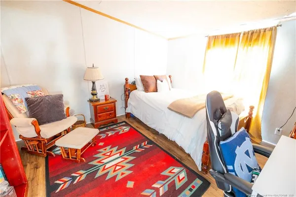 a bedroom with two beds and wooden floor