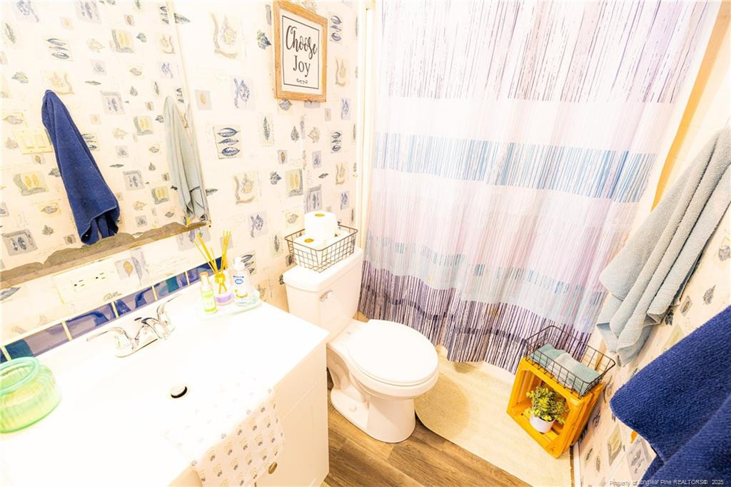 4471 Shannon Road Shannon, NC 28386 - Photo 17 of 17 a bathroom with a sink and a toilet