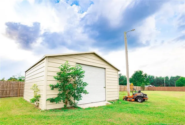a backyard of a house with table and chairs