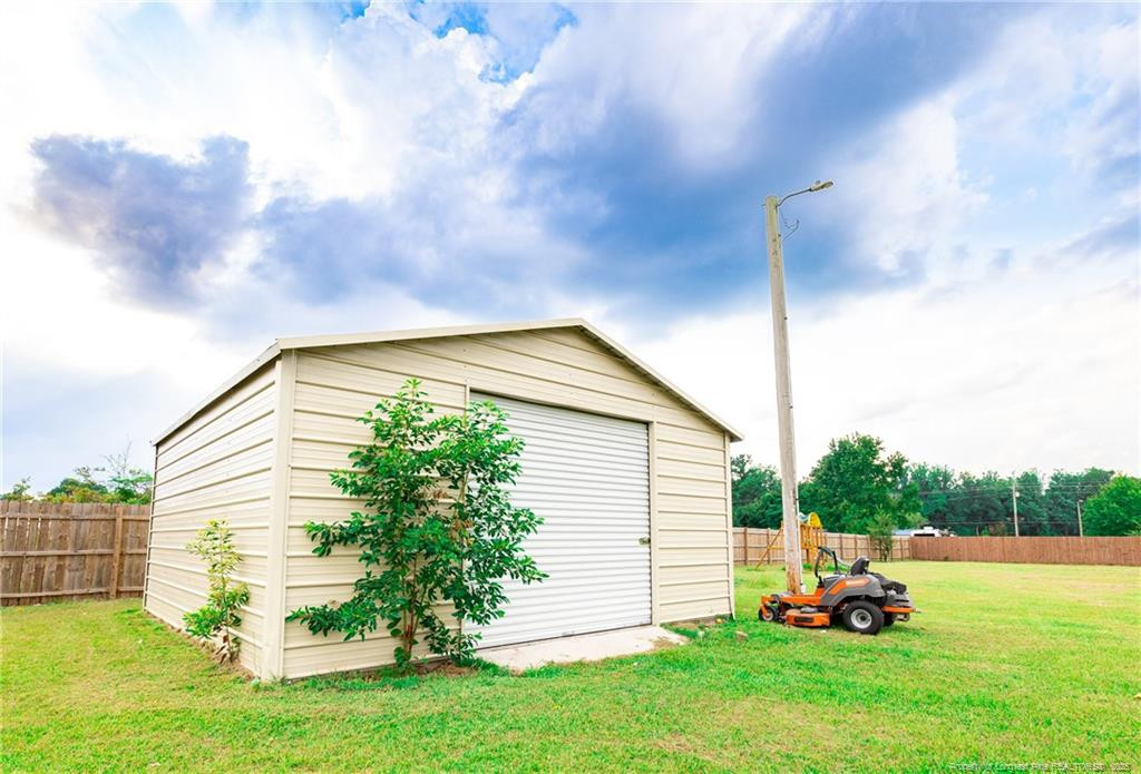 4471 Shannon Road Shannon, NC 28386 - Photo 3 of 17 a backyard of a house with table and chairs