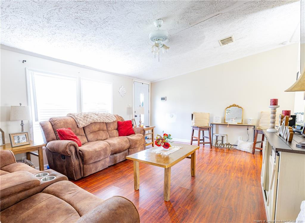 4471 Shannon Road Shannon, NC 28386 - Photo 7 of 17 a living room with furniture and a wooden floor
