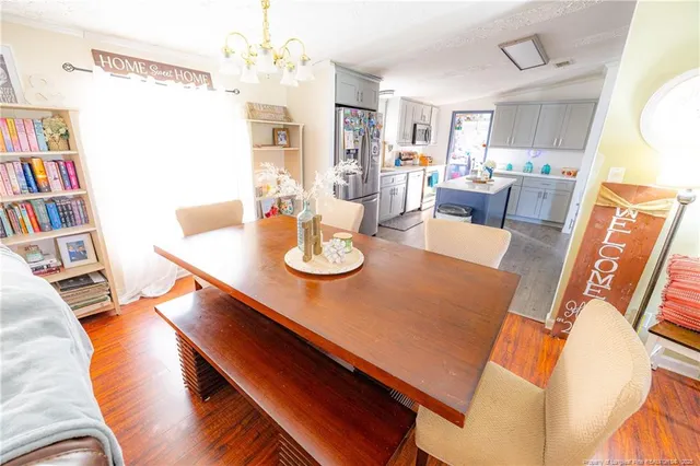 a view of a dining room with furniture and a book shelf