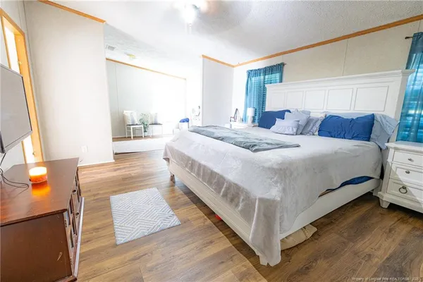 a bedroom with a bed and a night stand