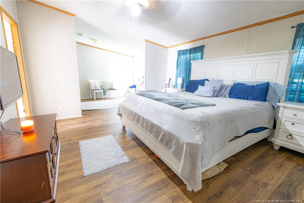 4471 Shannon Road Shannon, NC 28386 - Photo 10 of 17 a bedroom with a bed and a night stand