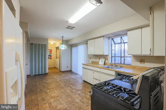 a kitchen that has a sink and a stove