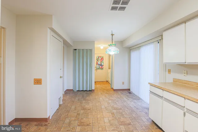 a view of a kitchen with a sink and cabinets
