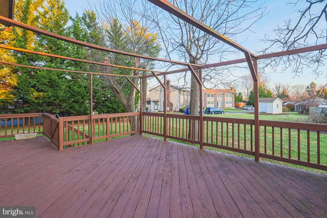 a view of a balcony with wooden floor and fence
