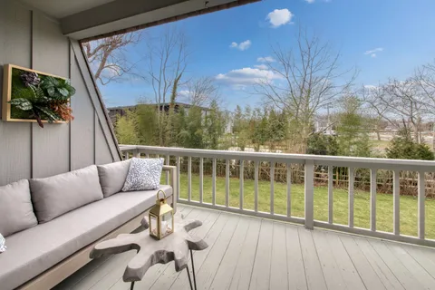 a balcony with furniture and a potted plant