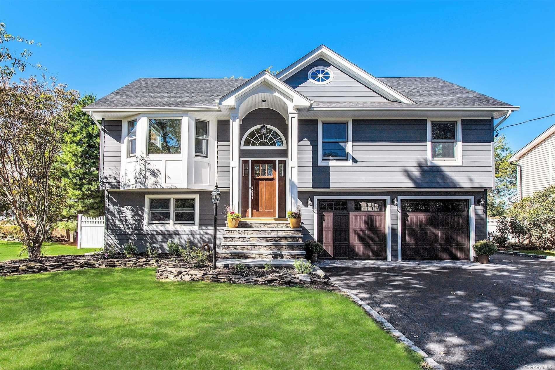 a front view of a house with a garden
