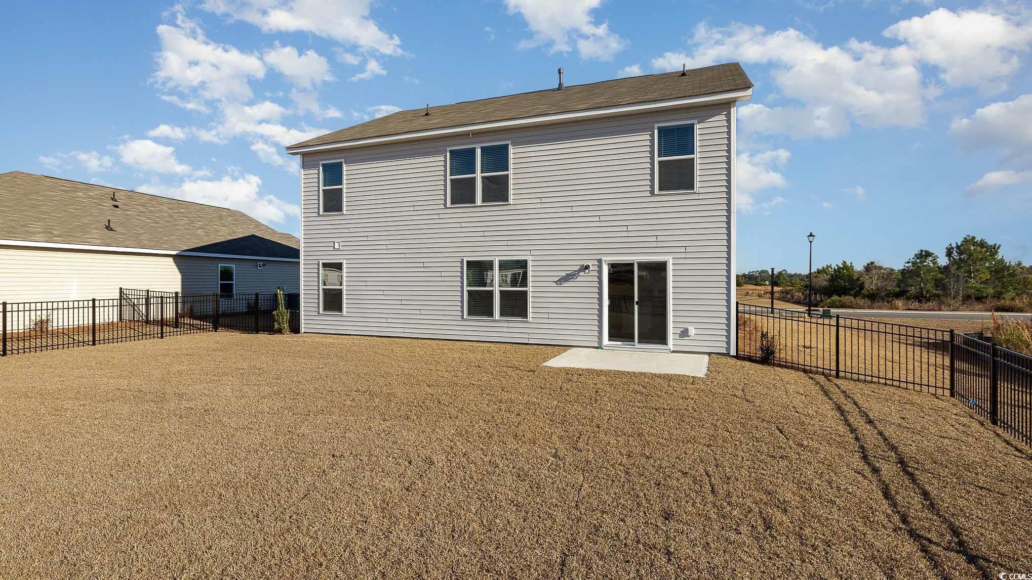 6054 Fuller Rdg Court Conway, SC 29526 - Photo 2 of 31 Back of house featuring a patio area and a lawn