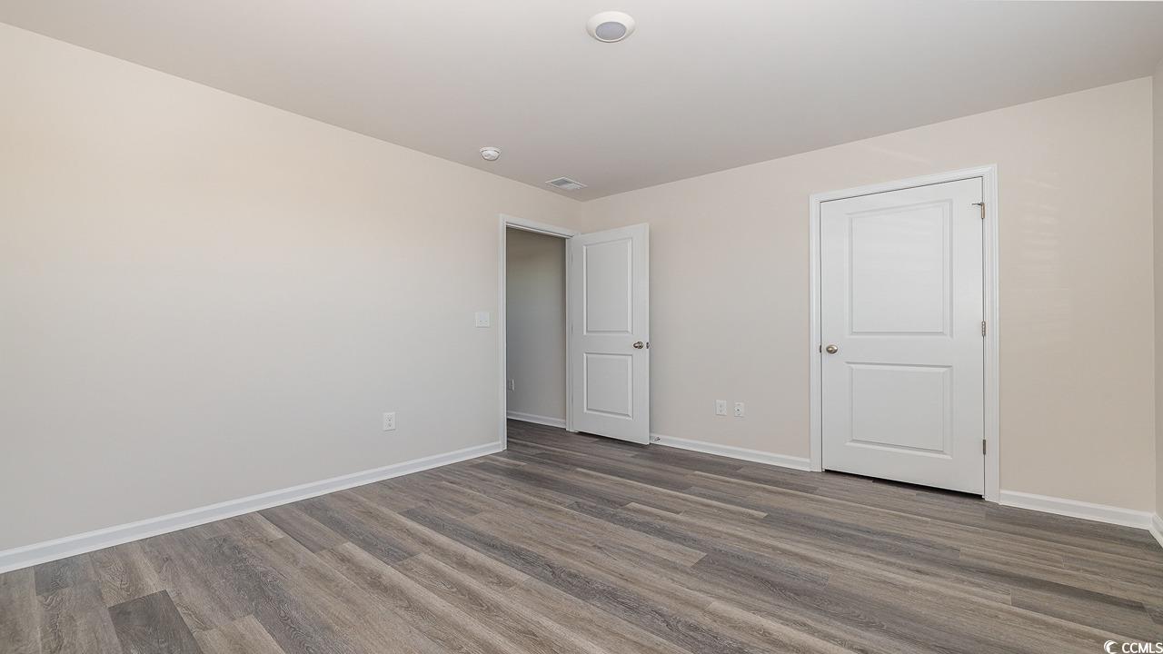 6054 Fuller Rdg Court Conway, SC 29526 - Photo 30 of 31 Unfurnished bedroom with dark wood-type flooring