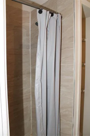 a bathroom with a shower and a mirror